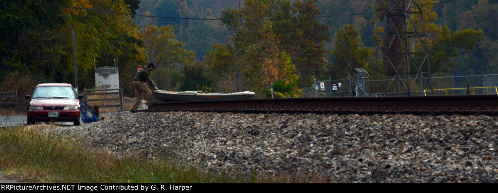 Individual pushes his craft across the right-of-way just ahead of the P00112's appearance